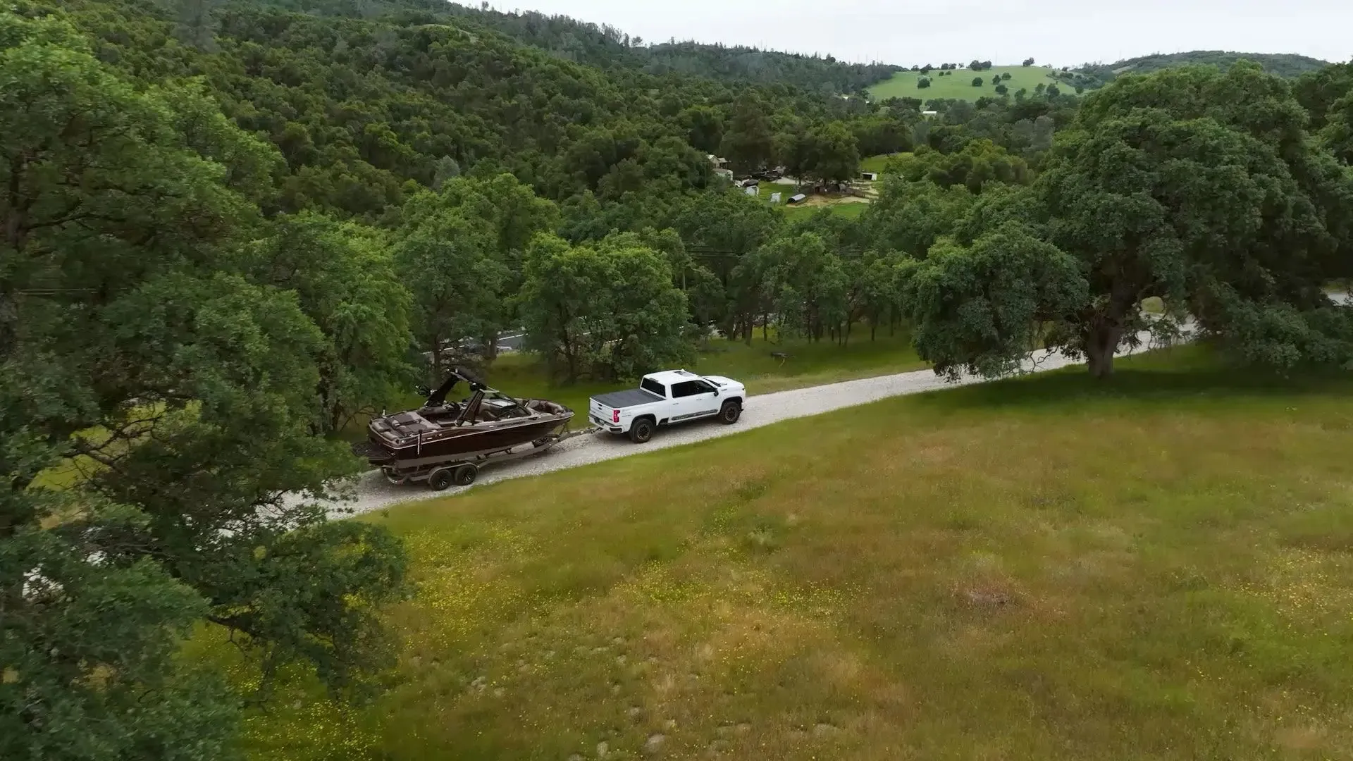 Truck Towing a Premium Pre-Owned Boat Through Beautiful Landscape